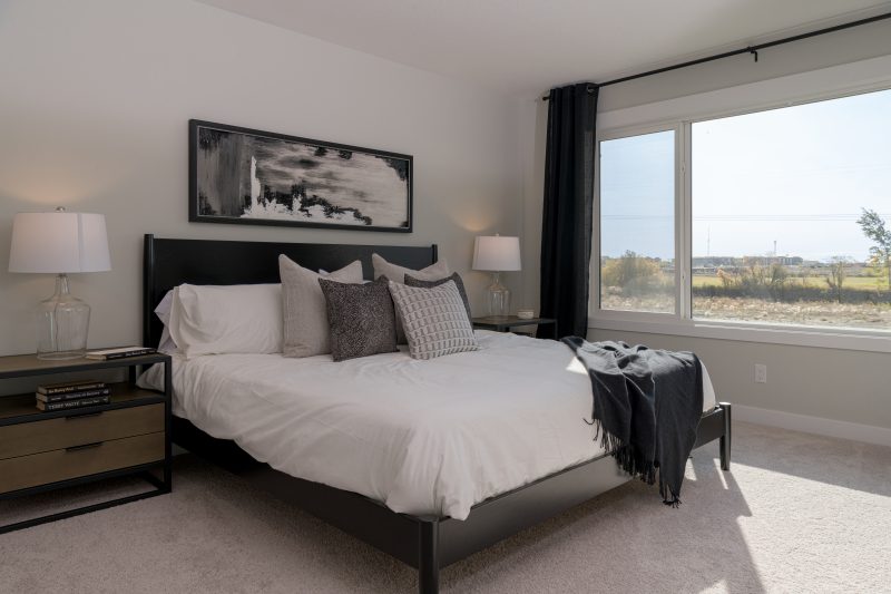 Primary bedroom in Anthem's front drive 110 showhome in Kinglet by Big Lake